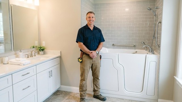 Walk-In Tub Contractor Scranton PA installer with a customer in their bathroom